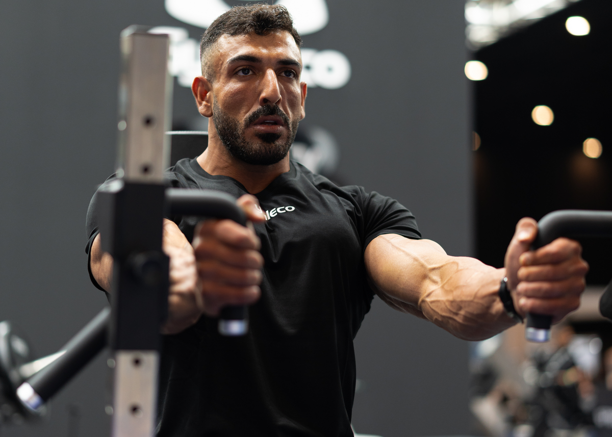 Man exercising in a gym with gymleko brand in the background