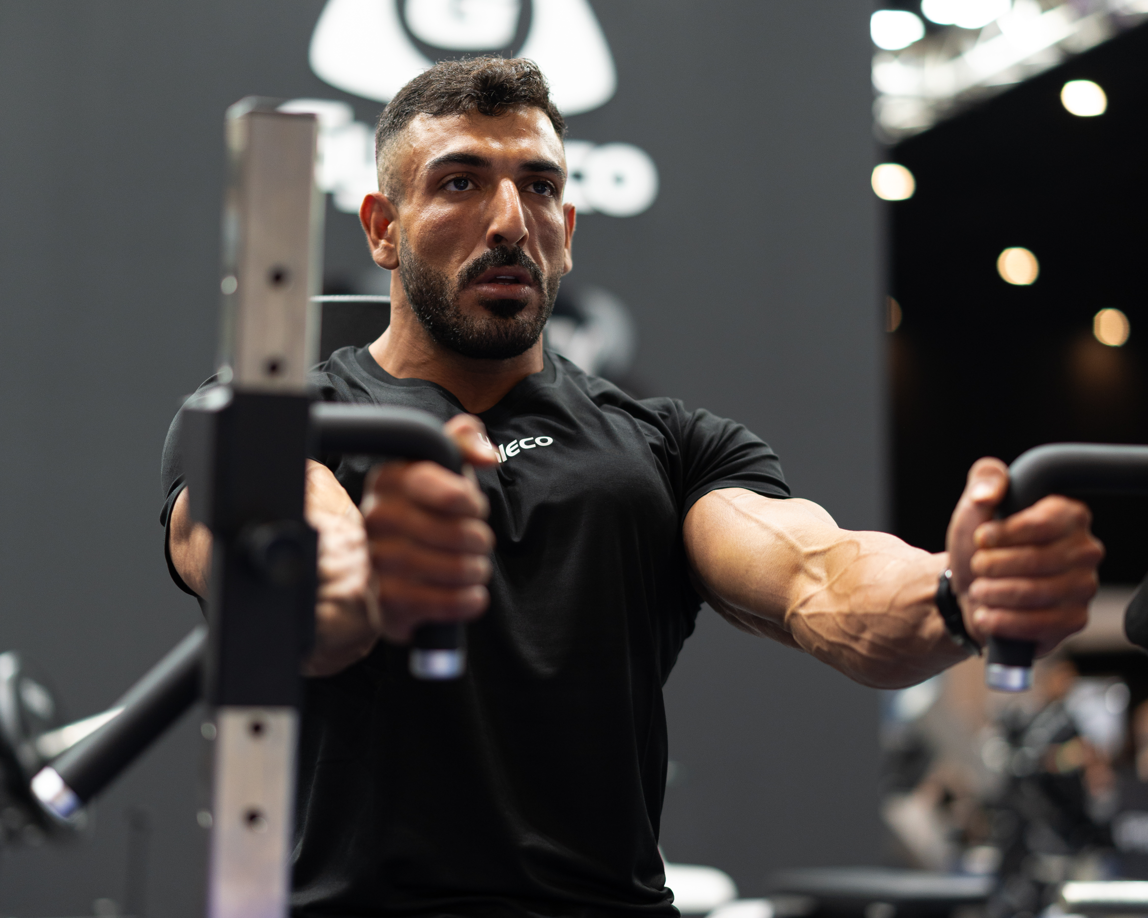 Man exercising in a gym with gymleko brand in the background